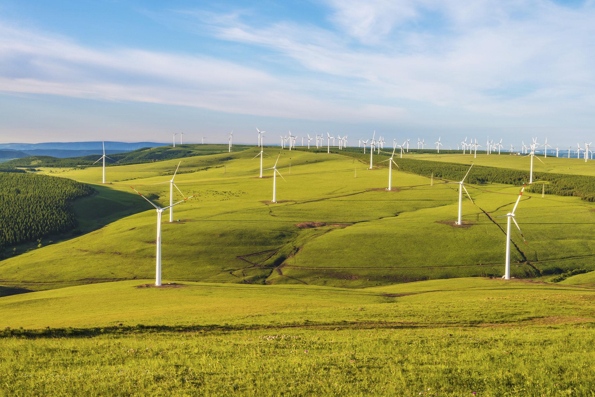 Wind farm across green hills